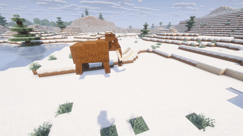 Mammoth walking in a snowy plain.