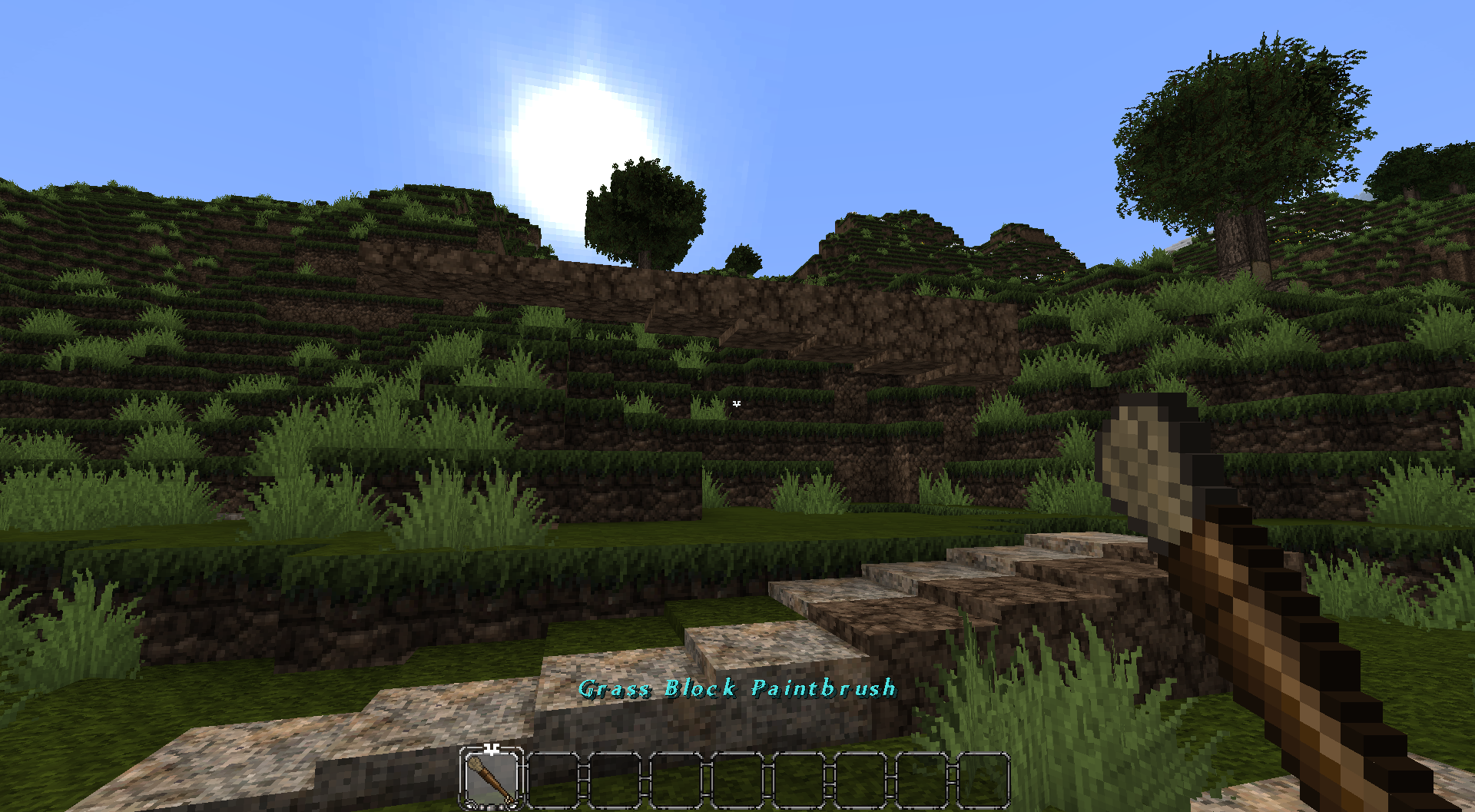 This screenshot shows a mix of grass, dirt, and limestone layer blocks from conquest reforged that can have their materials interchanged using this paintbrush.