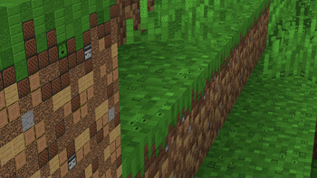 A photo of the side of a bunch of grass blocks from a hill