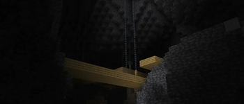 a sunlit "grimstone" deepslate cave with a suspended minecraft -- the header image used in the Minecraft Snapshot 21w07a article