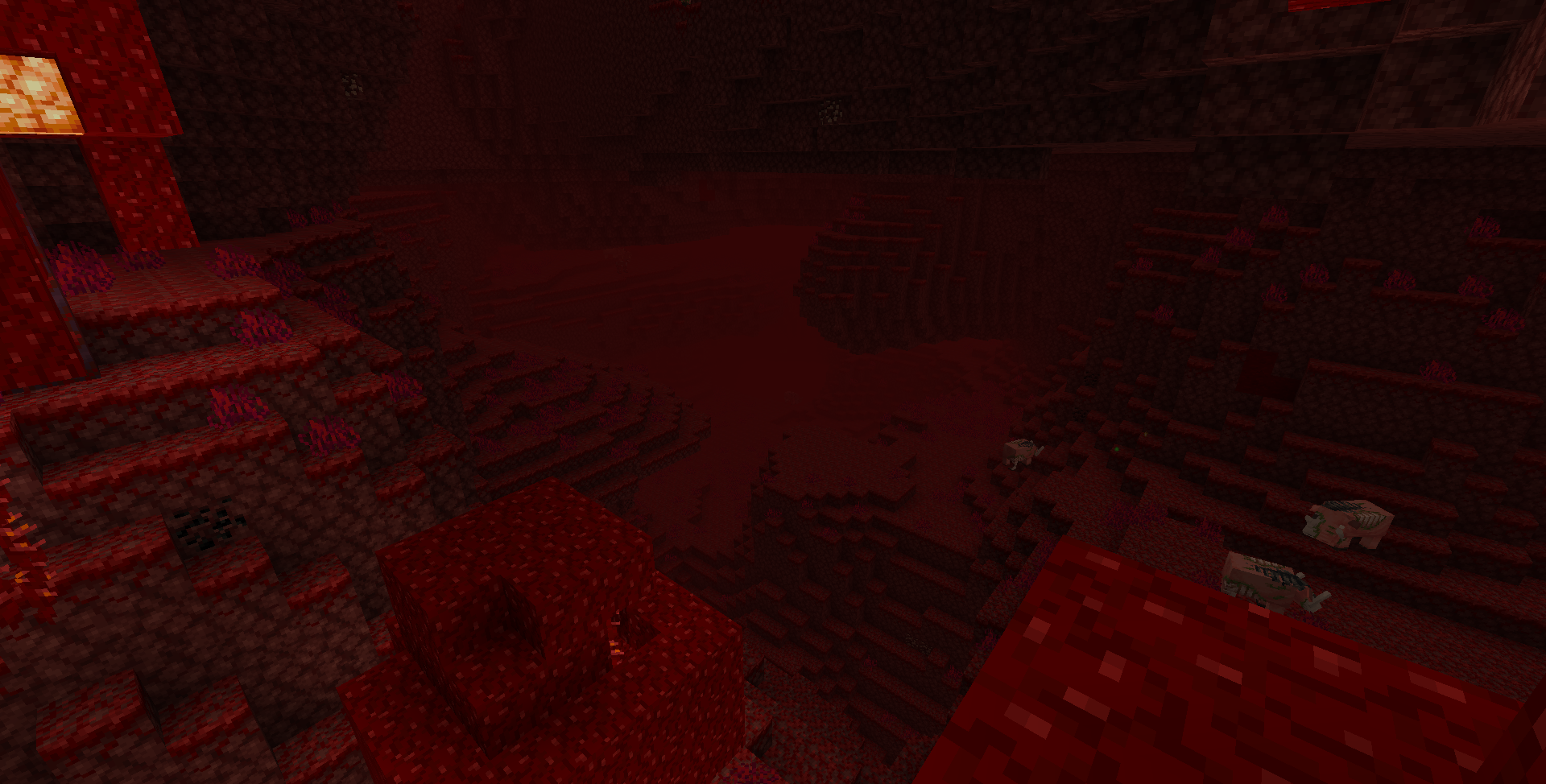 An image of a vast crimson valley biome, taken from the top of a giant crimson fungus in a neighboring crimson forest. The edge of the forest can be seen at the bottom and the left sides of the image. Three zoglins can be seen on the right of the image. Between them lie some experience orbs, indicating a mob has died there, presumably fighting the zoglins.